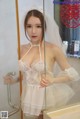 A woman in a wedding dress standing in front of a mirror.